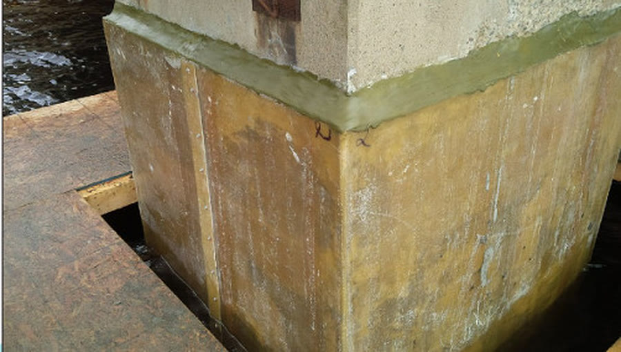 Underwater high-strength grout restoring a marine pile base at the waterline