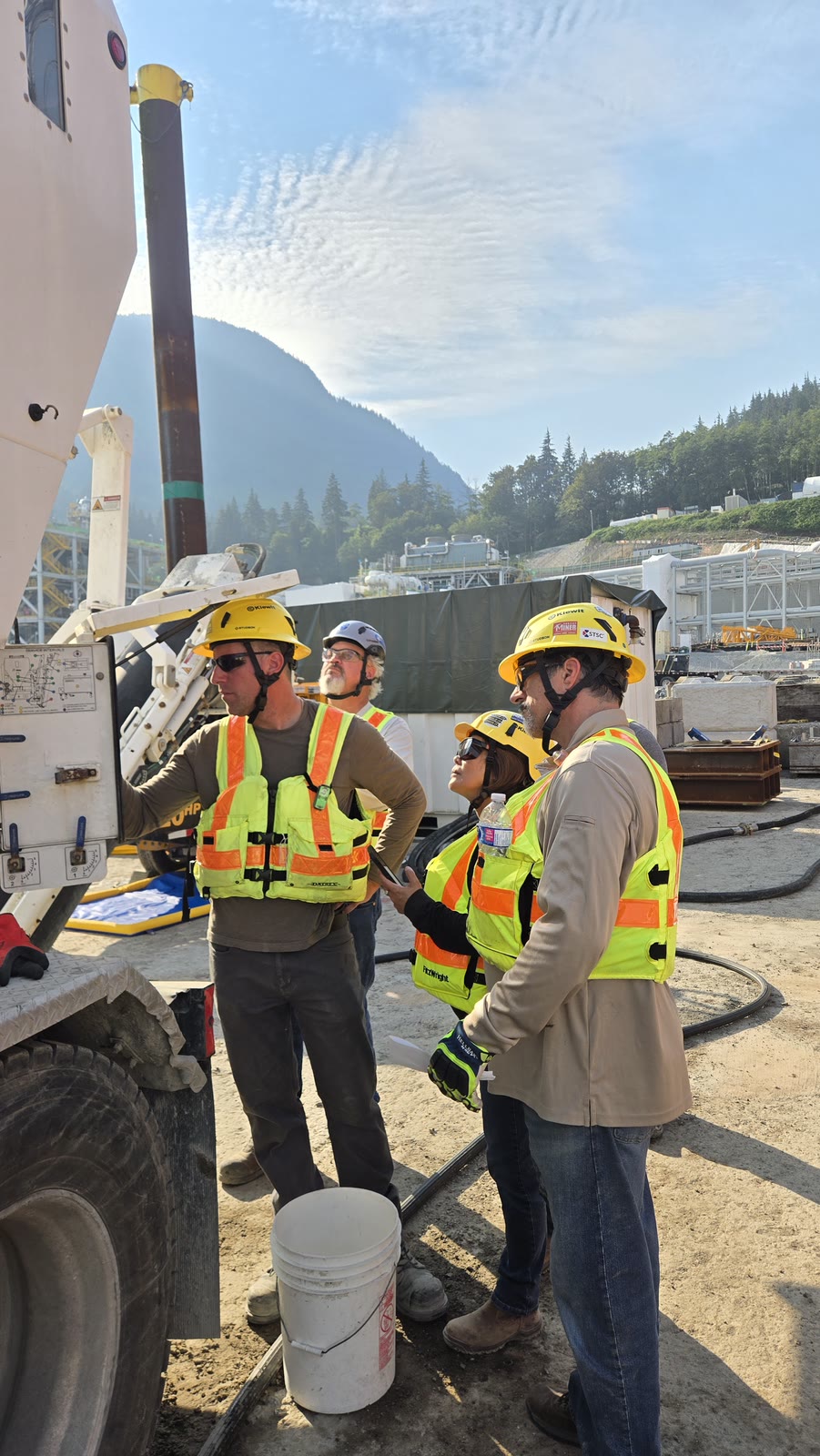 Sustainable Concrete crew verifying the mix at the volumetric truck control panel on site