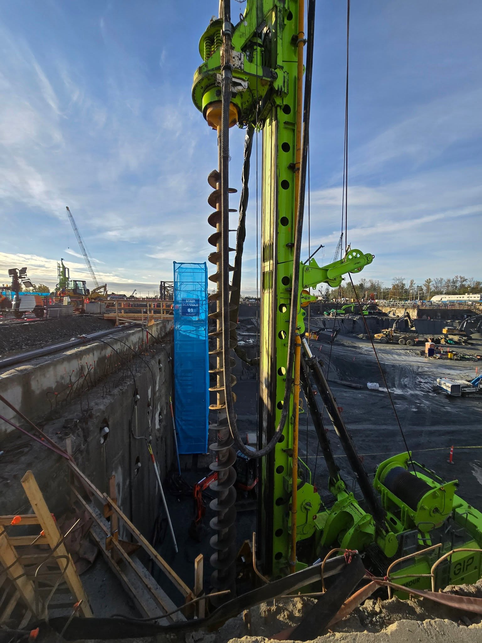CFA drilling rig and continuous flight auger operating on a deep foundation project