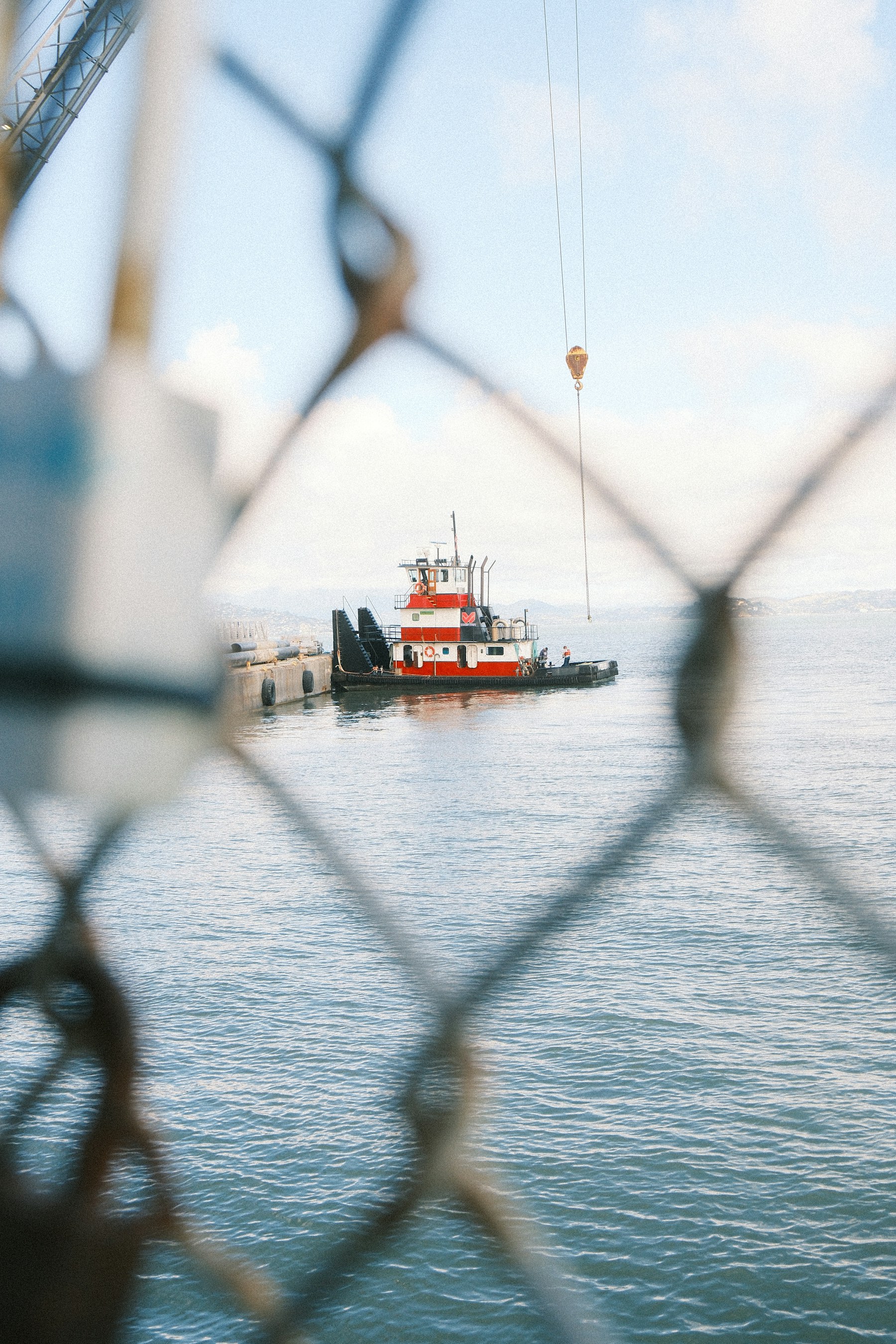 Industrial tugboat working beside a marine construction dock