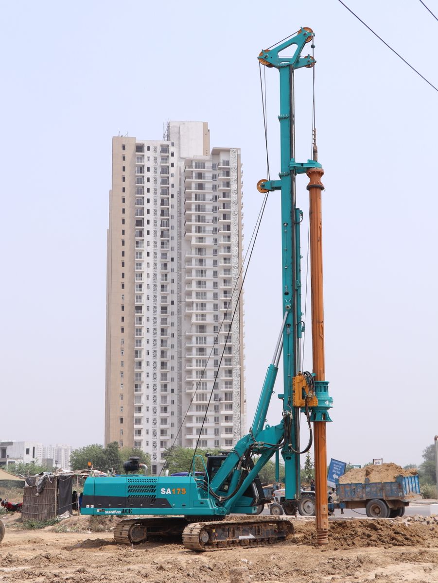 Large tracked piling rig drilling on an urban foundation site
